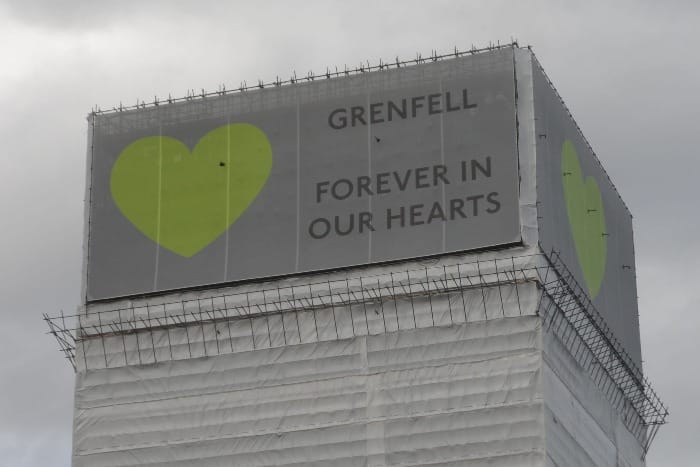  Grenfell Tower with banners at the top with heart symbol.